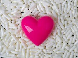 The heart  and white capsules image  for  sci or medical content. photo