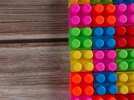 Toy brick on wood table photo