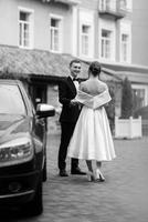 young couple bride and groom in a white short dress photo