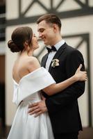 young couple bride and groom in a white short dress photo