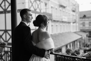 young couple bride and groom in a white short dress photo