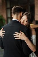 young couple bride and groom in a white short dress photo