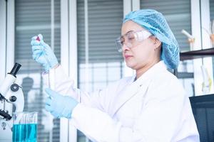 Asian woman scientist, researcher, technician, or student conducted research in laboratory photo