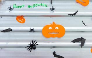 Halloween party concept. Pumpkins, bats, spiders on the decorated wall for halloween night party. photo