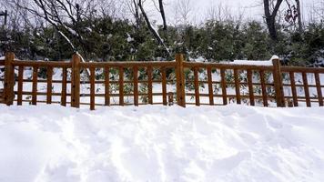 Snow walkway and wooden railing in the forest Noboribetsu onsen photo