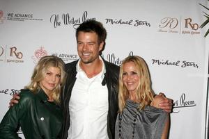 LOS ANGELES, NOV 9 - Fergie aka Stacey Ferguson, Josh Duhamel, Maria Bello at the WE ADVANCE Fundraising Event Hosted by Maria Bello at The Writer s Room on November 9, 2011 in Los Angeles, CA photo