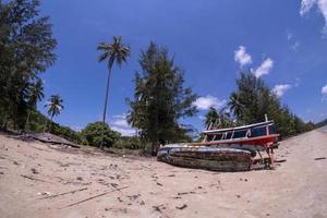 Houses and fishing boats are damaged. Fishing boats are not available on the beach. House collapsed photo