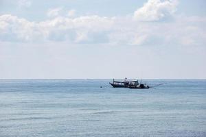 Small boats park by the sea. Small boats near the beach. Sandy beach at Sairee Beach, Chumphon Province photo