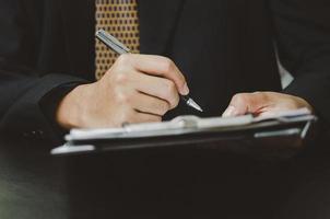 Business man person holding pen sign contract document. business lawyer or finance and insurance concept. photo