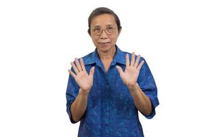 Asian elderly woman standing waving hands on background. photo
