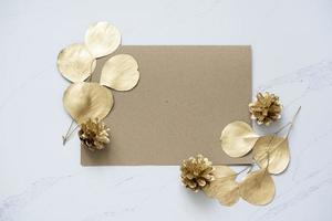 Mockup for a letter or a wedding invitation with leaves eucalyptus branches.