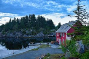 Norwegian red house fisherman cabin near a lake by the evening photo