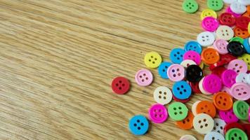 The  button multicolour  on wood table for background concept photo