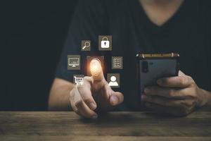 cyber security concept man's hand using a smartphone to the system through the fingerprint scanner Store data into online Cloud Data storag for security. photo