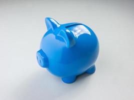 The blue piggy bank on white background for saving or business concept photo