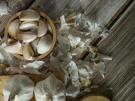 The garlic on wood table for food or cooking concept. photo