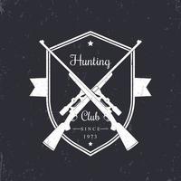 Hunting club vintage emblem, logo with crossed hunting rifles, white on dark, vector illustration