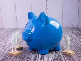 blue piggy bank on wood table for business concept photo