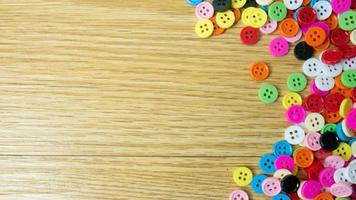 The  button multicolour  on wood table for background concept photo