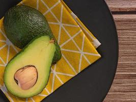 avocado on wood table top view image for food concept. photo