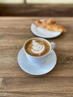 Hot coffee cup on table photo