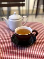 Hot tea cup on table photo
