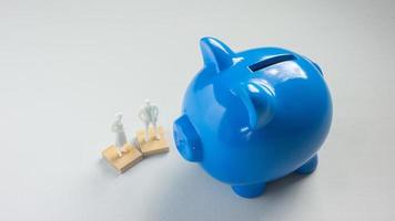 The blue piggy bank on white background for saving or business concept photo