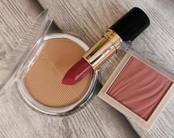 Cosmetic set with red lipstick, powder and blush photo