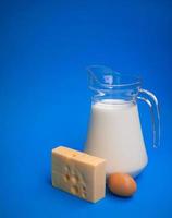 Dairy products. Milk, egg and cheese on a blue background