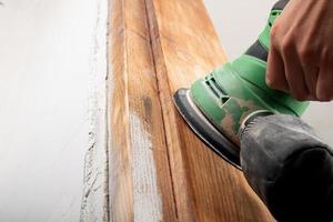 removing varnish from wood, processing and polishing wood with a grinder photo