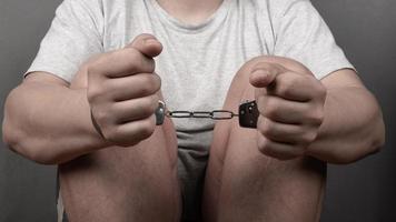 hands of a man in handcuffs, punishment for a crime criminal record photo