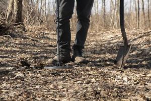 man search coins along old roads using a metal detector photo