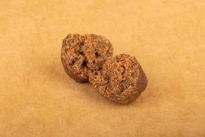 brown pieces of hashish on a yellow background, cannabis wax photo