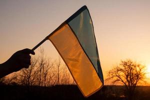 flag of ukraine against the backdrop of the sunset sky photo