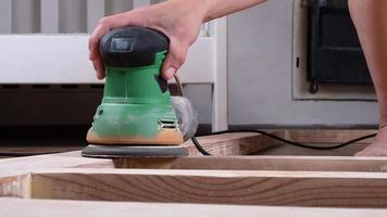 removing varnish from wood, processing and polishing wood with a grinder photo