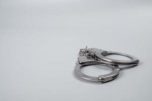handcuffs on a black background close-up, arrest detention copy space photo