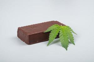 chocolate candy and cannabis leaf, thc sweets drugs photo