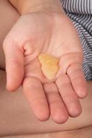 girl holding a piece of wax with a high content of THC in her hands photo