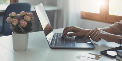 Businesswoman using calculator and laptop computer for analysis maketing plan, Accountant calculate financial report, computer with graph chart. Business, Finance and Accounting concept photo