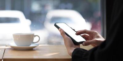 Closeup image of woman hands using smartphone, vertical view. photo