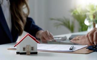 A professional female real estate agent receives a house loan payment or rent fee from her client. Property investment concept. cropped image photo