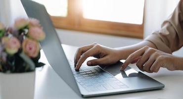 Businesswoman using laptop computer keyboard at the office. photo