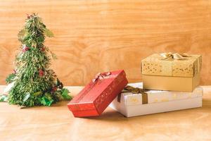 Gift boxes with Christmas decoration on wooden table background. photo