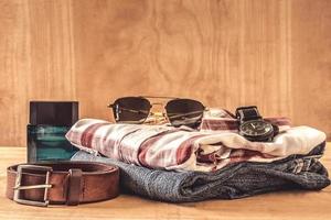 Male clothes and accessories on the wooden table. photo