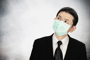 Man wearing mask protect fine dust in air pollution environment - people with protection equipment for air pollution concept photo