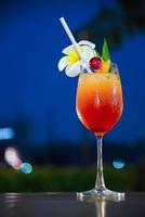 Cocktail recipe name mai tai or mai thai worldwide favour cocktail include rum lime juice orgeat syrup and orange liqueur - sweet alcohol drink with flower in twilight relax vacation concept photo