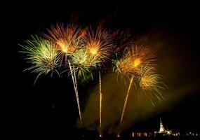 Huge, colorful fireworks over the rice fields at dusk. photo