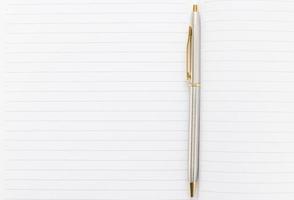 Pen and open notebook with blank page photo