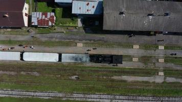 Aerial top down view of a steam train and locomotive in station