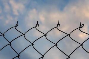 Wire mesh fence with sky nature background photo